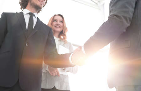 Photo of handshake of two happy businessmen