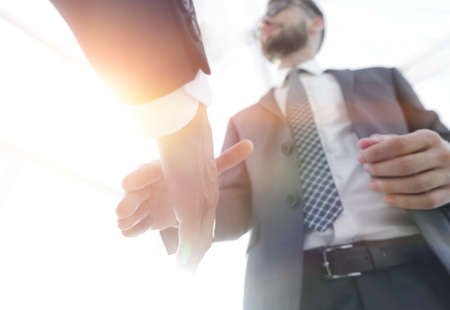 Two  business men going to make handshakeの写真素材