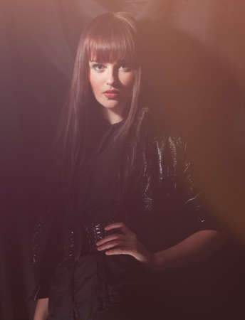 Woman with evening make-up posing on black background