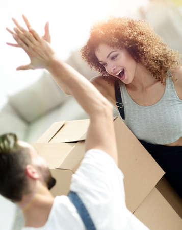 young couple giving five when moving to a new apartmentの写真素材