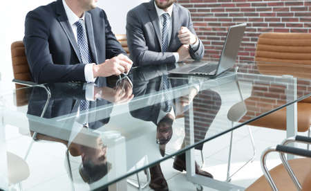 Two successful employees sitting at the deskの写真素材