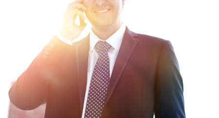 Close-up. Confident businessman talking smartphone.の写真素材