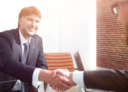 businessman stretches out his hand for a handshakeの写真素材