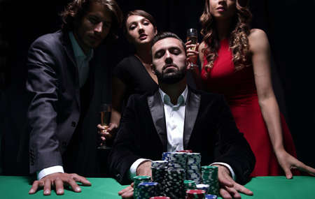 Attractive young caucasian man make bet in the casino
