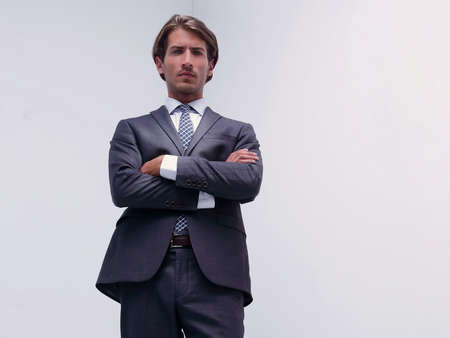 serious businessman standing in a blank room.