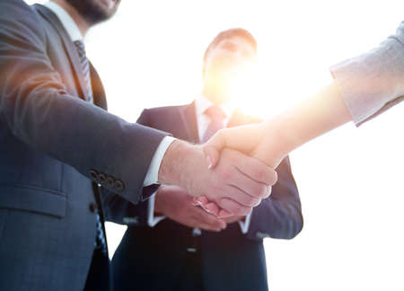 Business partners shaking hands in meeting hallの写真素材