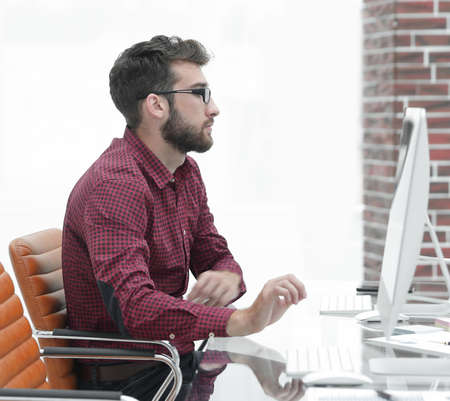 office worker sitting behind a Desk.
