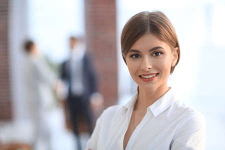 portrait of young business woman on the background of the officeの写真素材