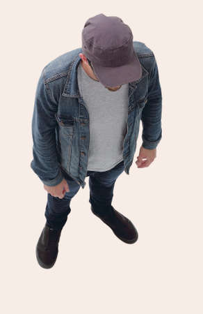 view from above. guy in a baseball cap and denim jacketの写真素材