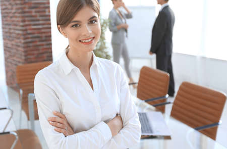 young woman assistant standing near desktop.の写真素材