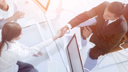view from the top. handshake the senior Manager and the employee