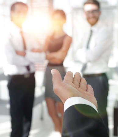 rear view.closeup. businessman holding out hand for a handshake.の写真素材