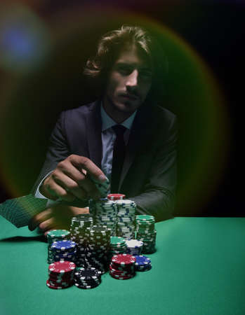 Young lucky gambler with cards and chips.の写真素材