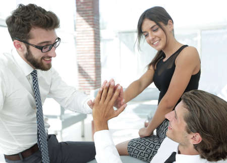 members of the business team give each other high five