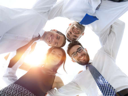 successful business people with arms around each others shoulder