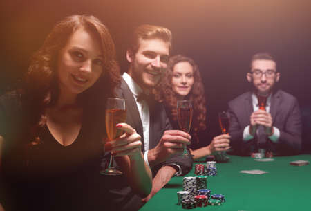 poker players with a glass of wine,sitting at the table