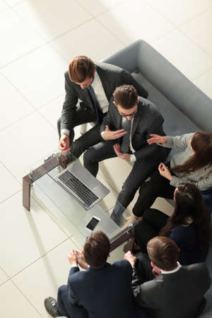 manager smiling with a laptop and his business team.の写真素材