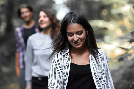 girl leader leads his team along a forest roadの写真素材