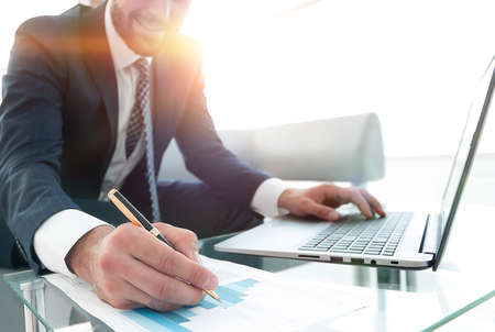 finance manager working with business graphics on a laptopの写真素材