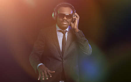 Black DJ in a club at the turntable