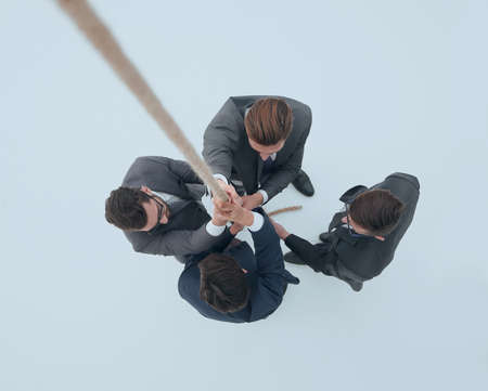 smiling business team holding the ropeの写真素材