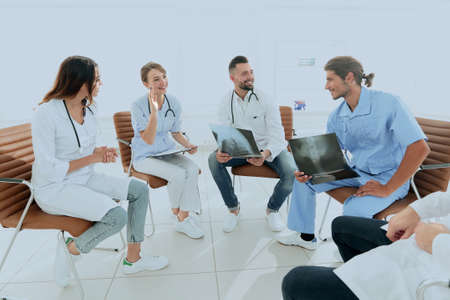 doctors discuss an x-ray ,sitting in the office.の写真素材
