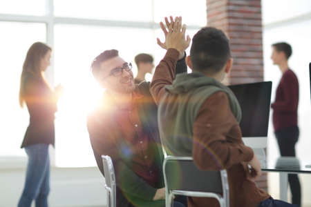 business colleagues giving each other high five