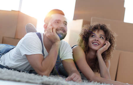 Happy couple on the background of cardboard boxesの写真素材