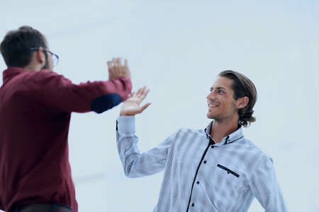 two business men giving each other a high five.