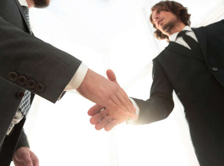 Two  business men going to make handshake