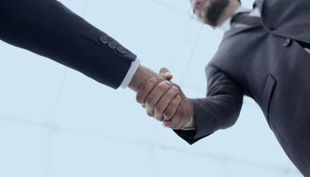 Two business people are holding hands to business cooperation.の写真素材
