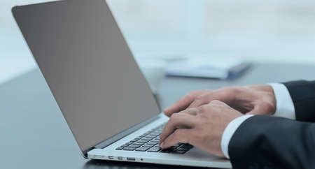 closeup.businessman working on laptop