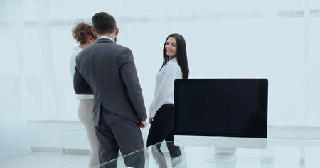 company employees standing in a modern office.