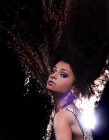 Young brunette woman dancing in a night disco club.