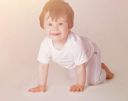 Happy crawling baby. Side view