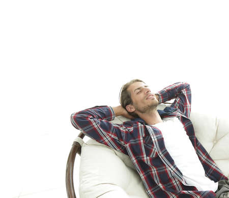 modern guy is resting sitting in a large comfortable chair. side view.の写真素材