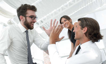 business colleagues giving each other high five.