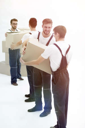 Photo workers pass each other boxes when moving flats.の写真素材