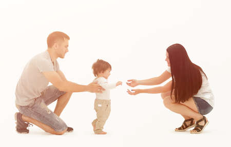 Portrait of a happy family that teaches a child to walkの写真素材