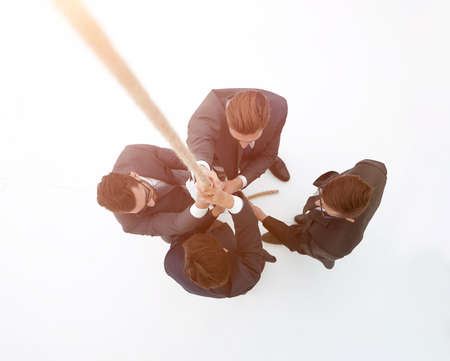 smiling business team holding the ropeの写真素材