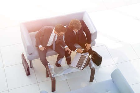 business colleagues discussing data from the laptop.の写真素材