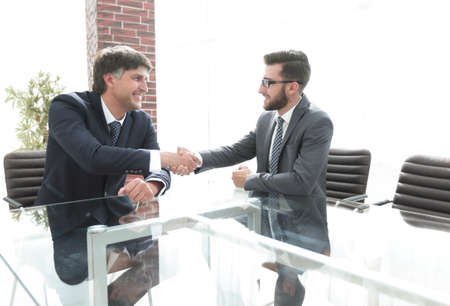 Business partners shake hands after discussing the contractの写真素材