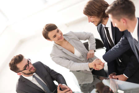 handshake business partners for their Deskの写真素材