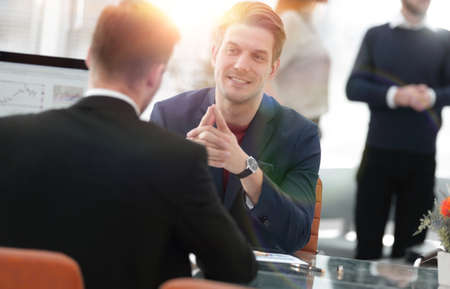 Two men discuss the growth of the company, looking at the rising graph on a computer screenの写真素材