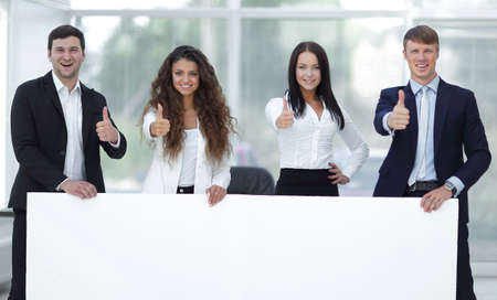 business team holding blank white bannerの写真素材