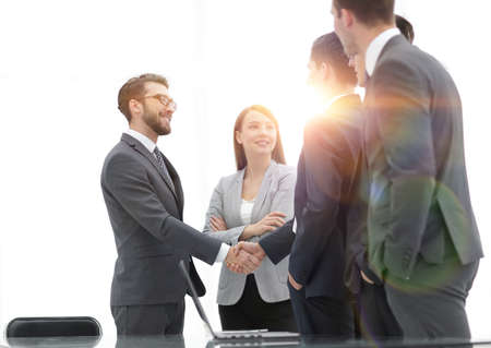 Successful business people shaking hands in an office.