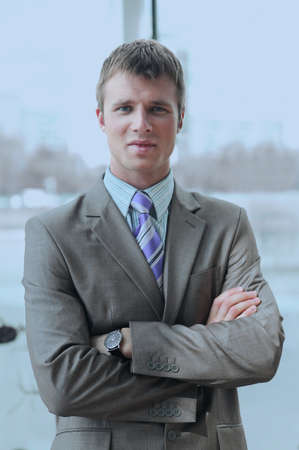 Portrait of happy businessman standing in officeの写真素材