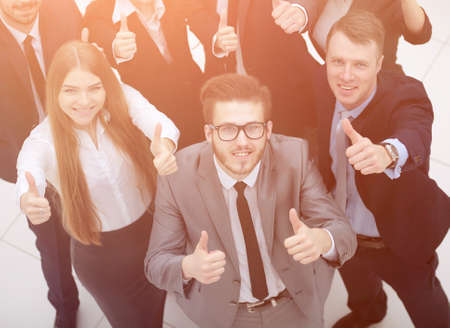 triumphant business team raised a thumbs up