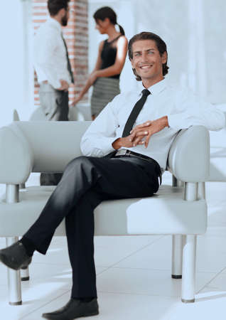 smiling businessman sitting in office chairの写真素材
