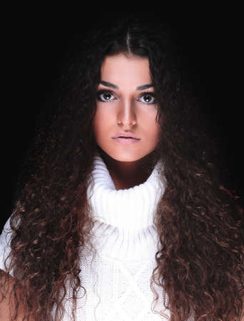 Portrait of a beautiful woman with curly hair in a sweater